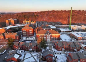 Aerial quad at sunrise in winter with snow on ground and moon in sky