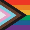Progress Pride Flag with a rainbow striped background of red, orange, yellow, green, blue, and purple with a chevron triangle on the left side comprised of white, pink, light blue, brown, and black
