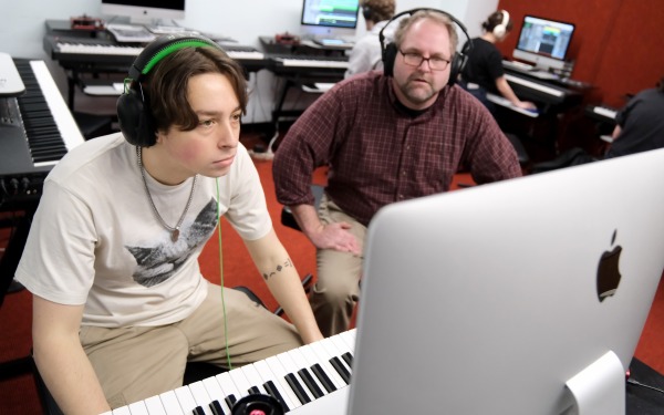 Justin Casinghino Music Professor and student working on keyboard with laptop