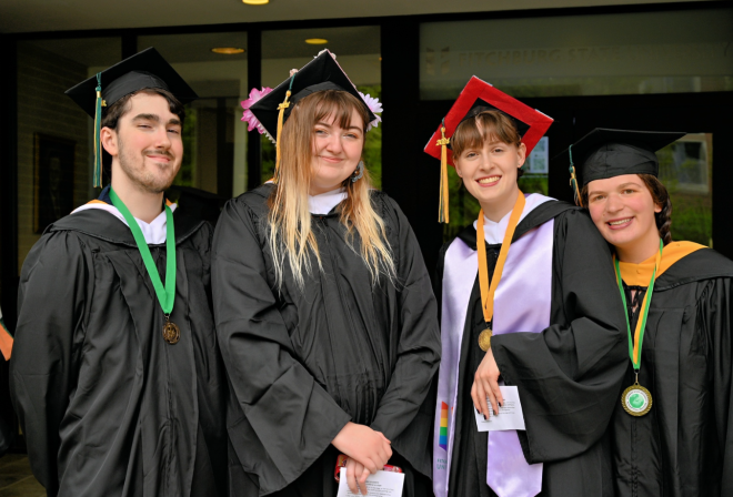 Photo of students smiling before start of commencement ceremony May 2024