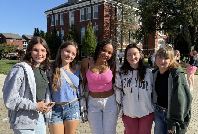 Group of female first year students smiling on the quad