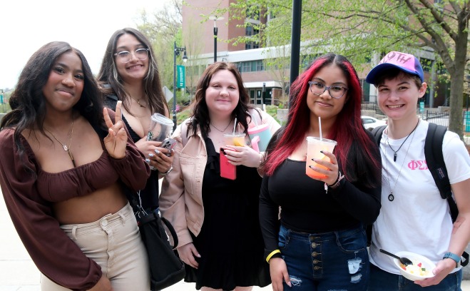 students holding drinks outside in front of Aubuchon hall 