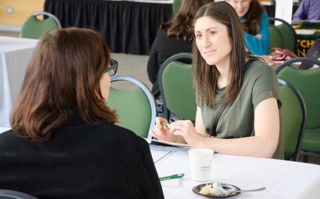 student and advisor sitting at table talking