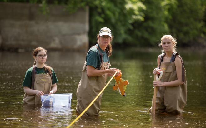 Students and teacher doing research for science class in Nashua River