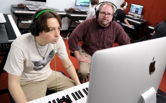 Justin Casinghino Music Professor and student working on keyboard with laptop