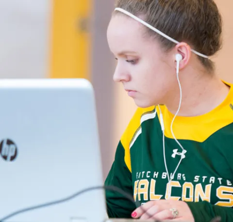 Woman In Library Doing Research on a Computer