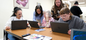 Jane Huang and Mary Kate Moreau work with residents for Digital Equity project at Joseph House