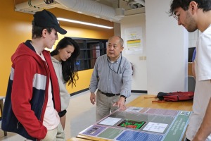 Professor talking with students in an Engineering Technology classroom