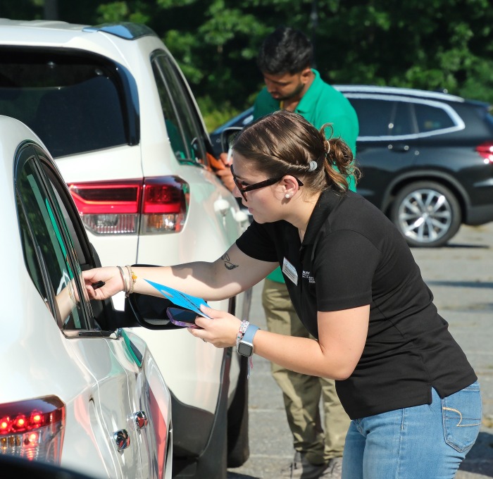 Housing staff checking cars in for move in