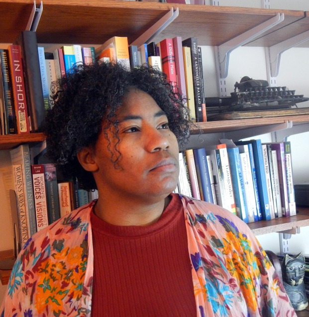 DeMisty D. Bellinger-Delfeld in front of a bookshelf with books