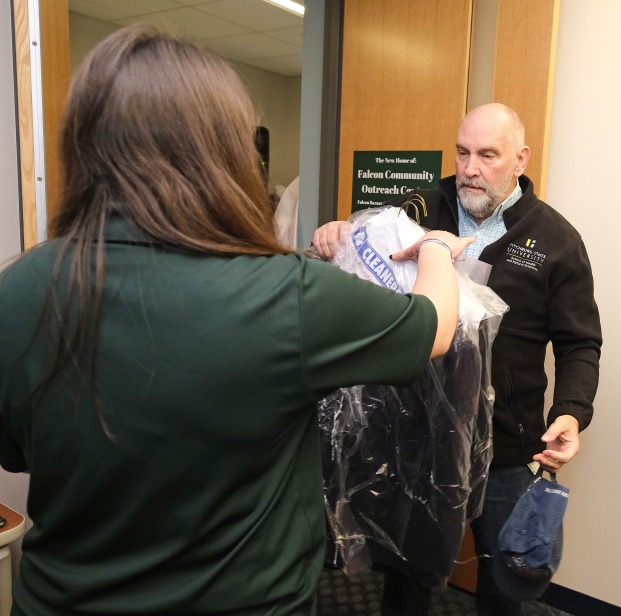 Staff member bringing items to donate to the clothing closet