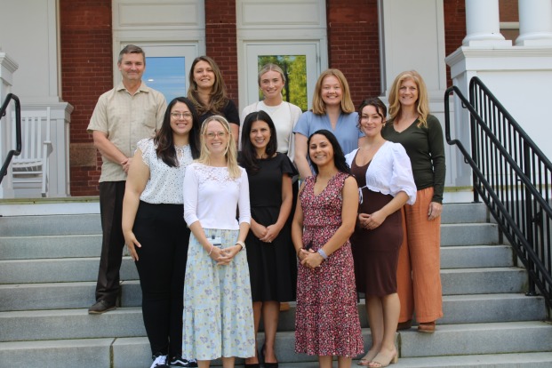 Group photo of the counseling services staff on steps of Thompson Hall