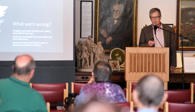 Dan Kennedy speaks from podium at journalism conference Aug 2024