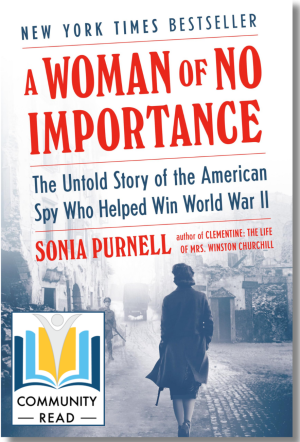 Book cover with the title A Woman of No Importance written in red, depicting a grey photo of a woman walking alone on a brick street. The cover also has a Community Read logo on it